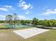 A beautiful day on the volleyball court with green tennis courts and trees in the background at 11519 Glenmont Dr, Tampa, FL 33635