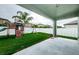 Inviting covered patio overlooking a well-manicured backyard with a playset, perfect for outdoor enjoyment at 1155 Lawnview Ter, New Port Richey, FL 34655