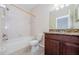 Bathroom featuring a bathtub with shower, tiled floors, and vanity at 1155 Lawnview Ter, New Port Richey, FL 34655