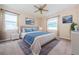 Inviting bedroom with a large bed, neutral decor, and ample natural light from the windows at 1155 Lawnview Ter, New Port Richey, FL 34655