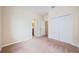 Bedroom featuring neutral carpet, a closet, and two doors at 1155 Lawnview Ter, New Port Richey, FL 34655