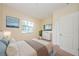 Bright bedroom featuring a large window, soothing artwork, and a cozy bed with plush pillows at 1155 Lawnview Ter, New Port Richey, FL 34655