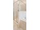 The primary bathroom has a shower with glass doors and tan tile walls at 1155 Lawnview Ter, New Port Richey, FL 34655