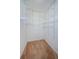 The walk-in closet features neutral carpet, white walls and wire shelving at 1155 Lawnview Ter, New Port Richey, FL 34655