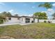 Exterior shot of a home's backyard featuring a patio and privacy fence at 11705 Ibis Ln, Port Richey, FL 34668
