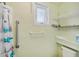 Bathroom featuring a shower with a handheld shower head, and a safety handle at 11705 Ibis Ln, Port Richey, FL 34668