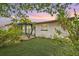 Charming home with a well maintained lawn and exterior featuring Florida vegetation at 11705 Ibis Ln, Port Richey, FL 34668