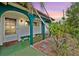 Inviting front porch features arched supports, bench seating and colorful accents at 11705 Ibis Ln, Port Richey, FL 34668