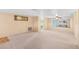 Living room with neutral walls, carpet, large mirror and ceiling fan at 11705 Ibis Ln, Port Richey, FL 34668