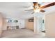 Living room with neutral walls, carpet, window, door to patio, and a ceiling fan with a light at 11705 Ibis Ln, Port Richey, FL 34668