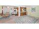 Bright dining and living area featuring tile floors, a ceiling fan, and large windows at 11705 Ibis Ln, Port Richey, FL 34668