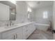 Modern bathroom with dual vanity, white cabinets, soaking tub and luxury finishes at 1550 48Th N Ave, St Petersburg, FL 33703
