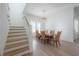 Dining room features a wooden table, six chairs, a pendant light, and a staircase at 1550 48Th N Ave, St Petersburg, FL 33703