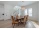 Bright dining room with wooden table, six chairs, and large windows at 1550 48Th N Ave, St Petersburg, FL 33703