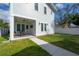 Exterior of the home showing the patio, ceiling fan, and grassy backyard at 1550 48Th N Ave, St Petersburg, FL 33703