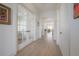 Elegant hallway with hardwood floors and glass-paned doors offers a bright and airy transition at 1550 48Th N Ave, St Petersburg, FL 33703