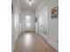 Bright hallway with hardwood floors, white trim, and stylish decor, leading to various rooms at 1550 48Th N Ave, St Petersburg, FL 33703