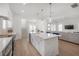 Open-concept kitchen featuring a large island with a farmhouse sink and stainless steel appliances at 1550 48Th N Ave, St Petersburg, FL 33703