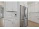 Clean white kitchen with quartz countertops, shaker cabinets, and stainless steel refrigerator at 1550 48Th N Ave, St Petersburg, FL 33703