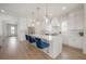 An airy, open kitchen featuring a center island with barstool seating and pendant lighting at 1550 48Th N Ave, St Petersburg, FL 33703