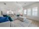 Open living room with a large sofa, area rug, and kitchen in the background at 1550 48Th N Ave, St Petersburg, FL 33703
