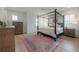 Main bedroom with a four-poster bed, wood floors, and plantation shutters at 1550 48Th N Ave, St Petersburg, FL 33703