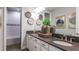Tastefully designed bathroom featuring a double vanity, gray countertop, and decorative accents at 1725 Trailhead Ln, Zephyrhills, FL 33541