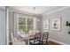 Bright dining room with modern chandelier, stylish chairs, and a view of the outdoor space at 1725 Trailhead Ln, Zephyrhills, FL 33541