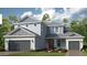 Charming two-story home with attached two-car garage and well-maintained landscaping at 1725 Trailhead Ln, Zephyrhills, FL 33541