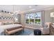 Main bedroom suite featuring a large bed and window view of screened in patio at 1725 Trailhead Ln, Zephyrhills, FL 33541