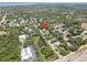 Community aerial view shows the home's location near a pond and main road at 1810 Pine Hill Dr, Safety Harbor, FL 34695