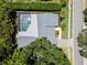 Aerial view of property featuring screened pool, mature trees, and privacy at 1810 Pine Hill Dr, Safety Harbor, FL 34695