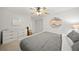 Bright bedroom with a comfortable bed, dresser, ceiling fan, and closet at 1810 Pine Hill Dr, Safety Harbor, FL 34695
