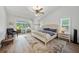 Bright bedroom featuring a ceiling fan, and sliding glass doors leading to the outdoor pool area at 1810 Pine Hill Dr, Safety Harbor, FL 34695