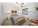 Well-lit bedroom with neutral tones, complemented by a comfortable bed and stylish wooden decor at 1810 Pine Hill Dr, Safety Harbor, FL 34695