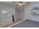 Bright bedroom featuring a ceiling fan, closet, and dresser for ample storage at 1810 Pine Hill Dr, Safety Harbor, FL 34695