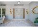 Inviting front entrance featuring tiled patio and unique decorative hardware at 1810 Pine Hill Dr, Safety Harbor, FL 34695