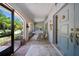 Cozy front porch area with stylish seating and screened doorway entrance at 1810 Pine Hill Dr, Safety Harbor, FL 34695