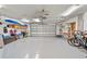 Spacious two-car garage with ample storage, painted floors, and a ceiling fan at 1810 Pine Hill Dr, Safety Harbor, FL 34695