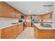 Open kitchen with light wood cabinets, white counters, and stainless steel appliances at 1810 Pine Hill Dr, Safety Harbor, FL 34695