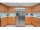 Kitchen featuring stainless steel appliances, light wood cabinetry, and mosaic tile backsplash at 1810 Pine Hill Dr, Safety Harbor, FL 34695