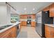 Updated kitchen features stainless steel appliances and light wood cabinetry at 1810 Pine Hill Dr, Safety Harbor, FL 34695