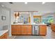 Bright kitchen with custom cabinetry, stainless steel appliances, and a view to the outdoor living area at 1810 Pine Hill Dr, Safety Harbor, FL 34695