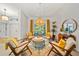 Comfortable living room with four chairs, patterned rug, and decorative lighting at 1810 Pine Hill Dr, Safety Harbor, FL 34695
