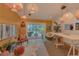 Cozy living room with chairs, pendant lights, and backyard pool access at 1810 Pine Hill Dr, Safety Harbor, FL 34695