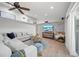 Bright and open living room featuring modern decor, wood floors, and decorative shelving at 1810 Pine Hill Dr, Safety Harbor, FL 34695