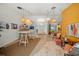 Inviting living room with stylish decor, pendant lighting, bar, and open entryway at 1810 Pine Hill Dr, Safety Harbor, FL 34695