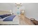 Light-filled main bedroom with ceiling fan, tv, and ensuite bathroom access at 1810 Pine Hill Dr, Safety Harbor, FL 34695