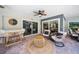 Comfortable covered patio featuring modern furniture, ceiling fan, and sliding glass doors at 1810 Pine Hill Dr, Safety Harbor, FL 34695