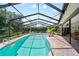 Private pool area with screened enclosure, lush landscaping, and lounge chairs for ultimate relaxation and outdoor enjoyment at 1810 Pine Hill Dr, Safety Harbor, FL 34695